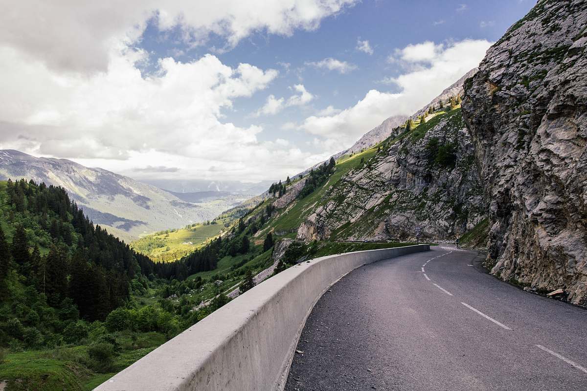 mountains curved road near cliff trees