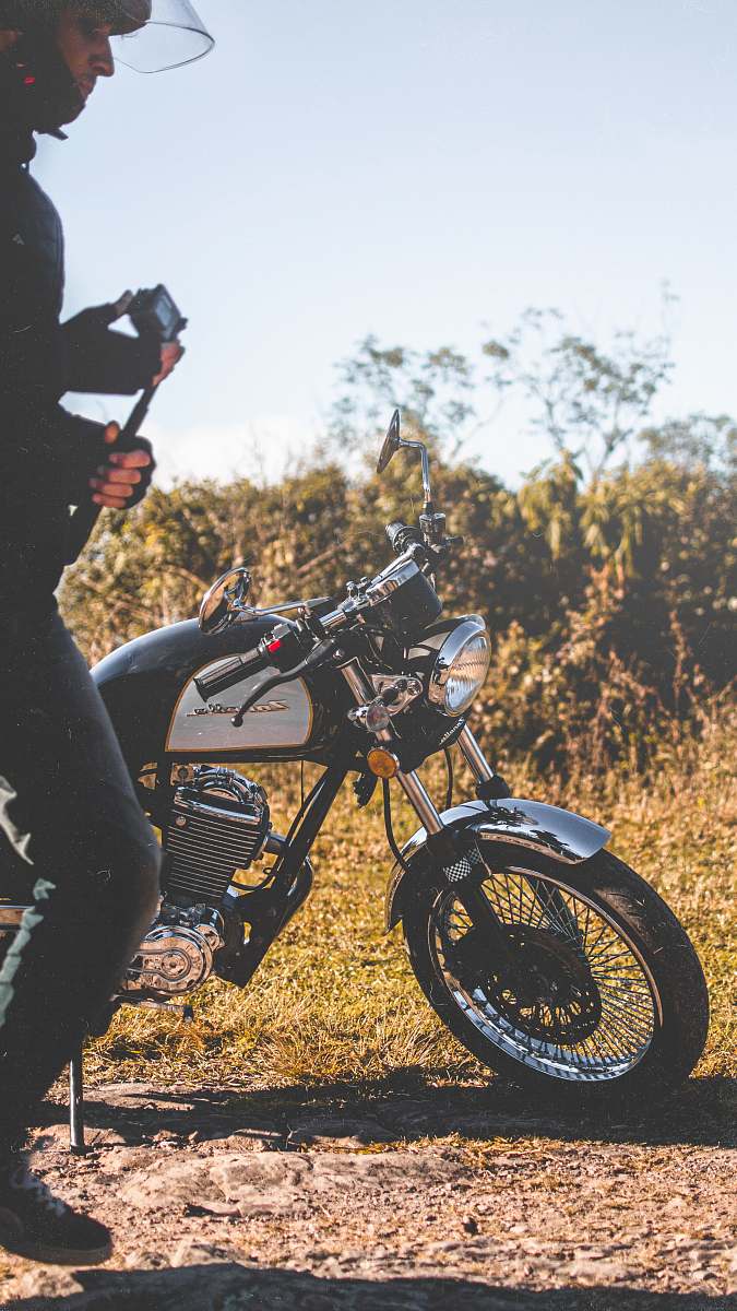 wheel man beside a black and white motorcycle motorcycle
