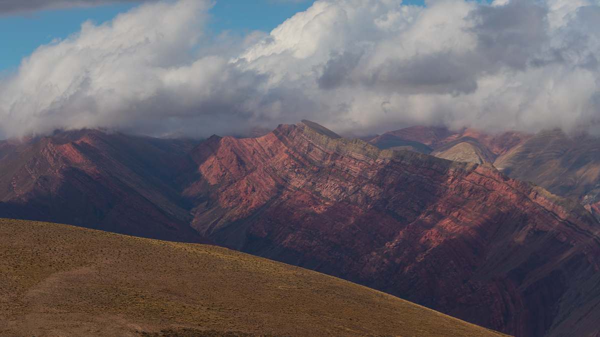 outdoors brown rocky mountain under white cloudy sky during daytime mountain