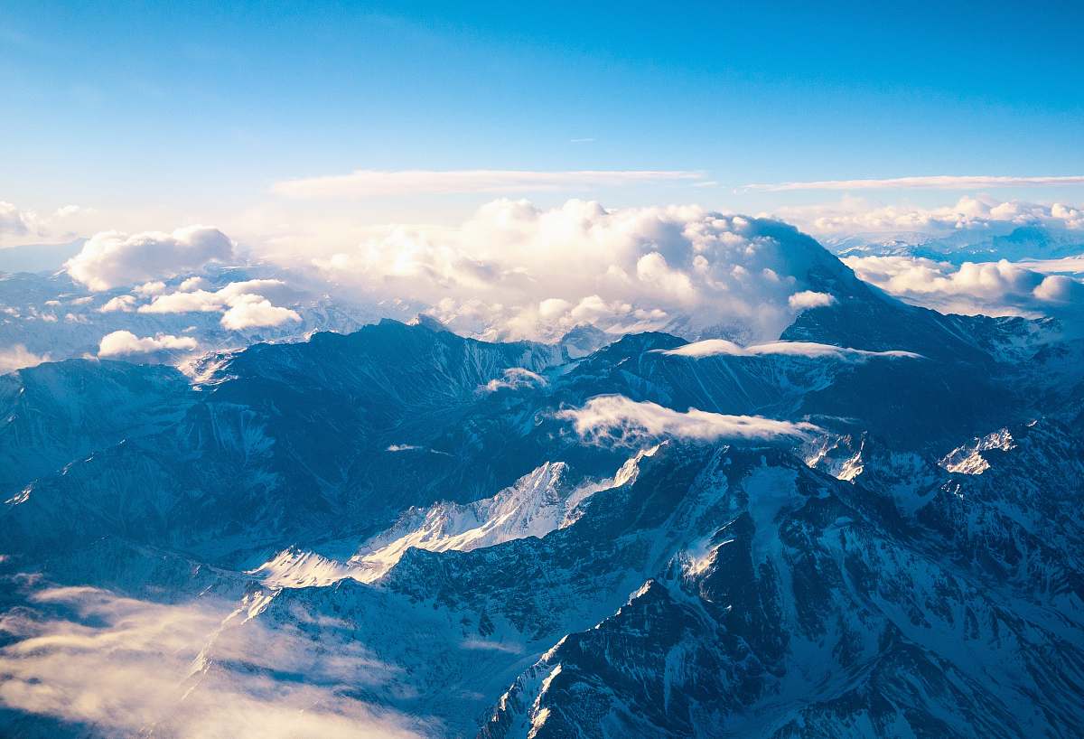 mountain mountain ranges covered in clouds snow