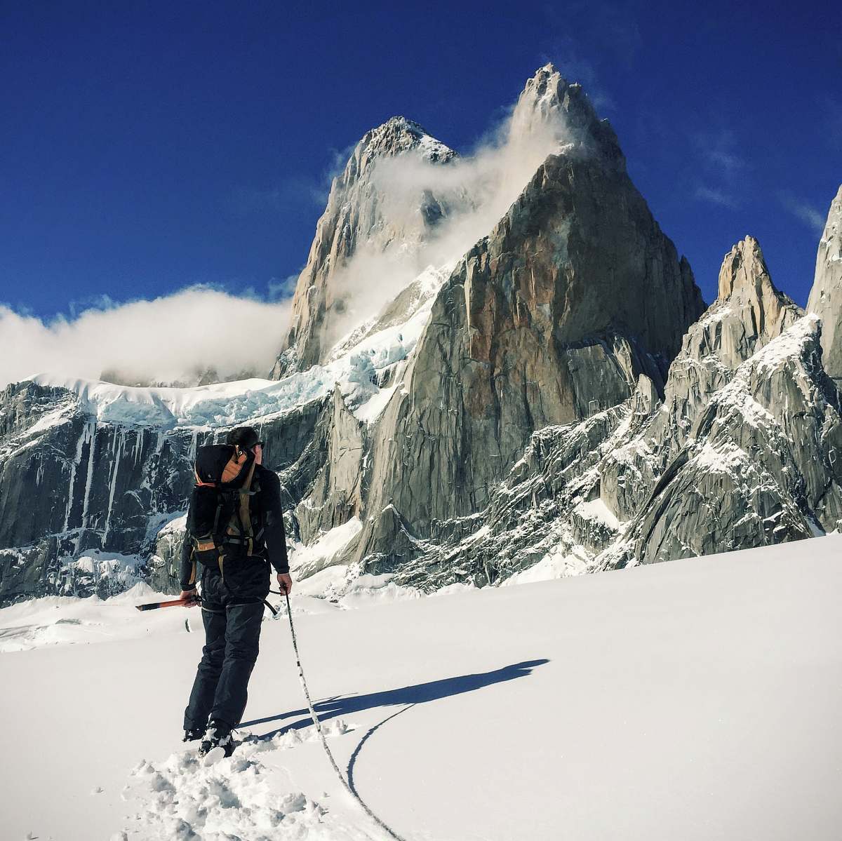 ice person walking on snow field near mountain mountain