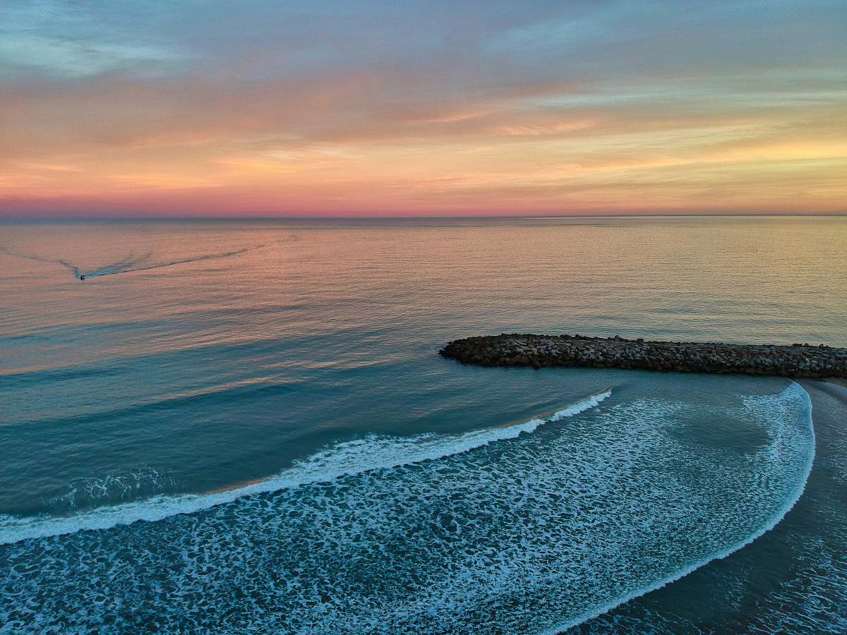 ocean water waves on shore during golden hour outdoors