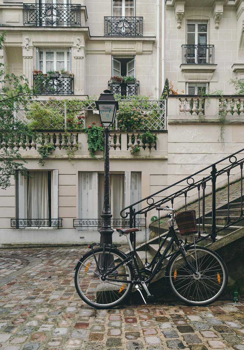 france bike leaning against handrail in front of concrete building at daytime bike