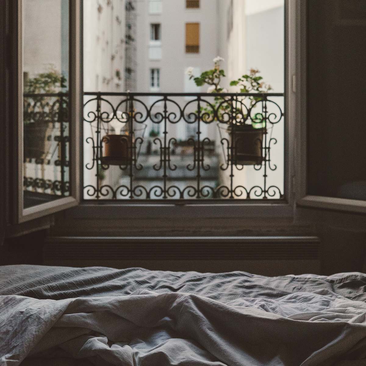 bed closeup photo of open window with flower window