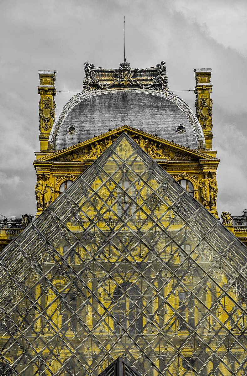 architecture photo of glass triangle-shape building under nimbus cloud structure