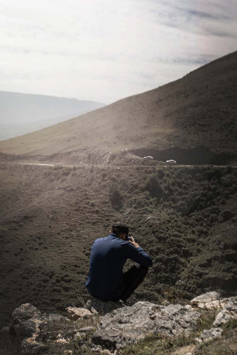 argentina man sitting on mountain human