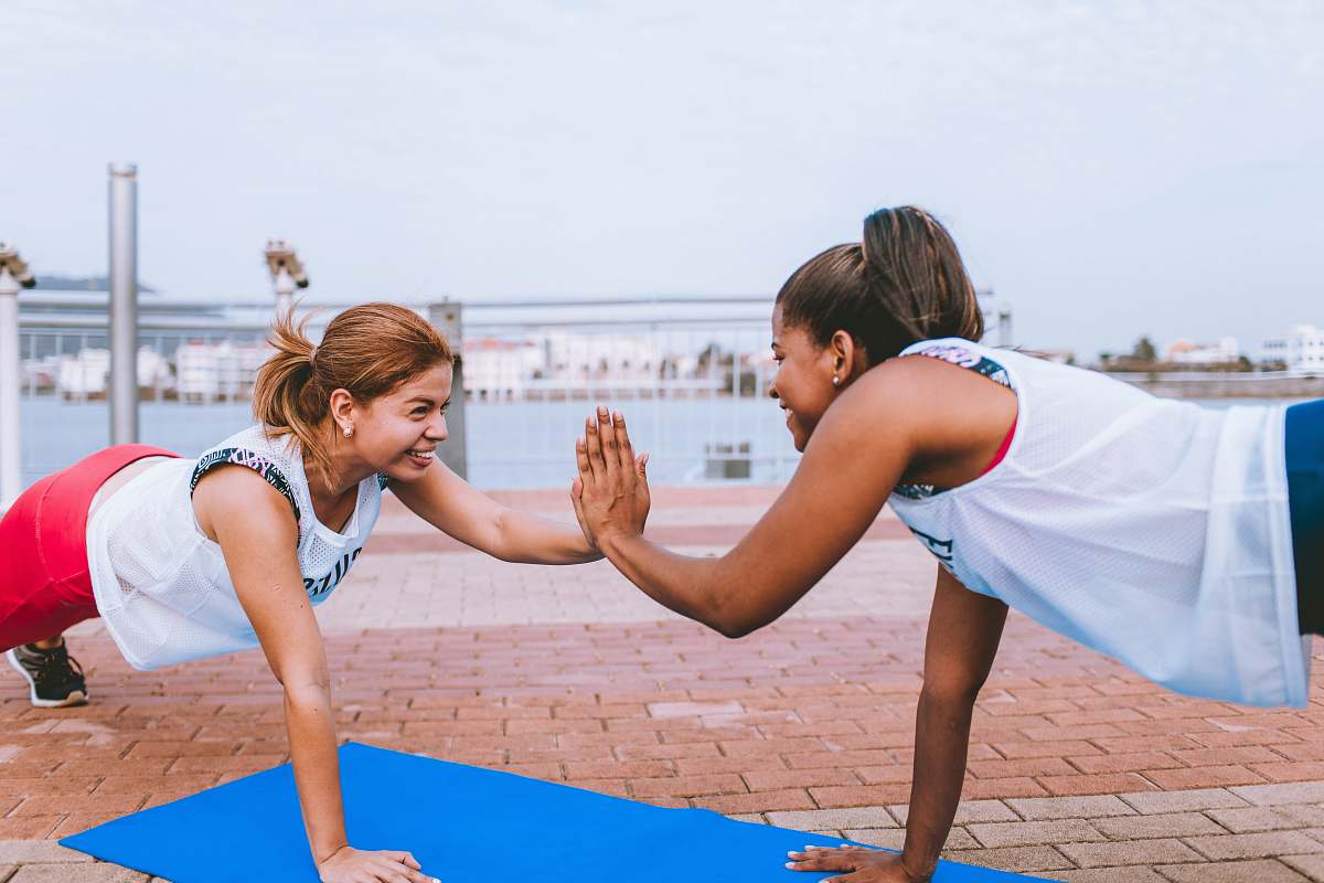 human two women doing push up fitness