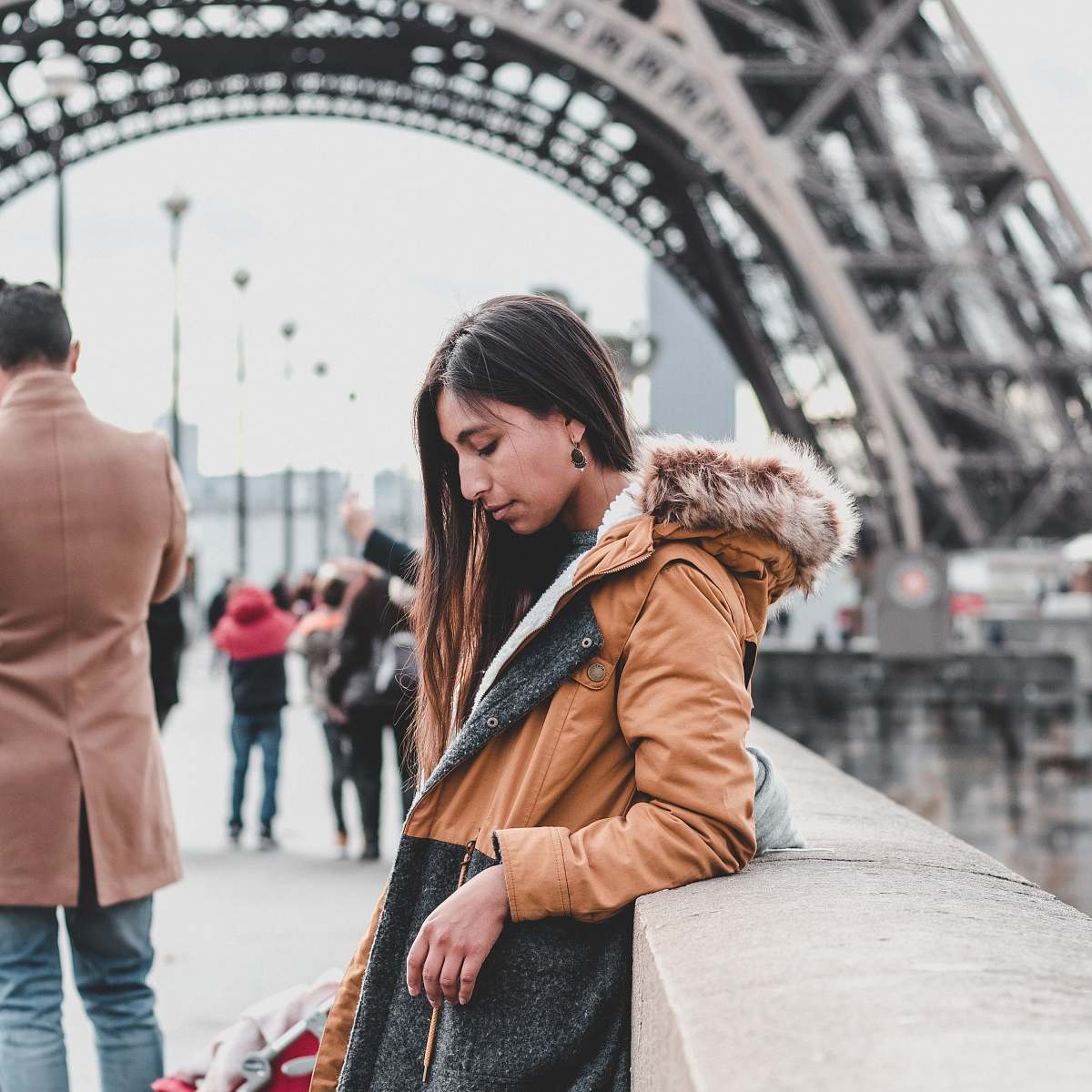 apparel woman leaning against wall near Eiffel Tower clothing