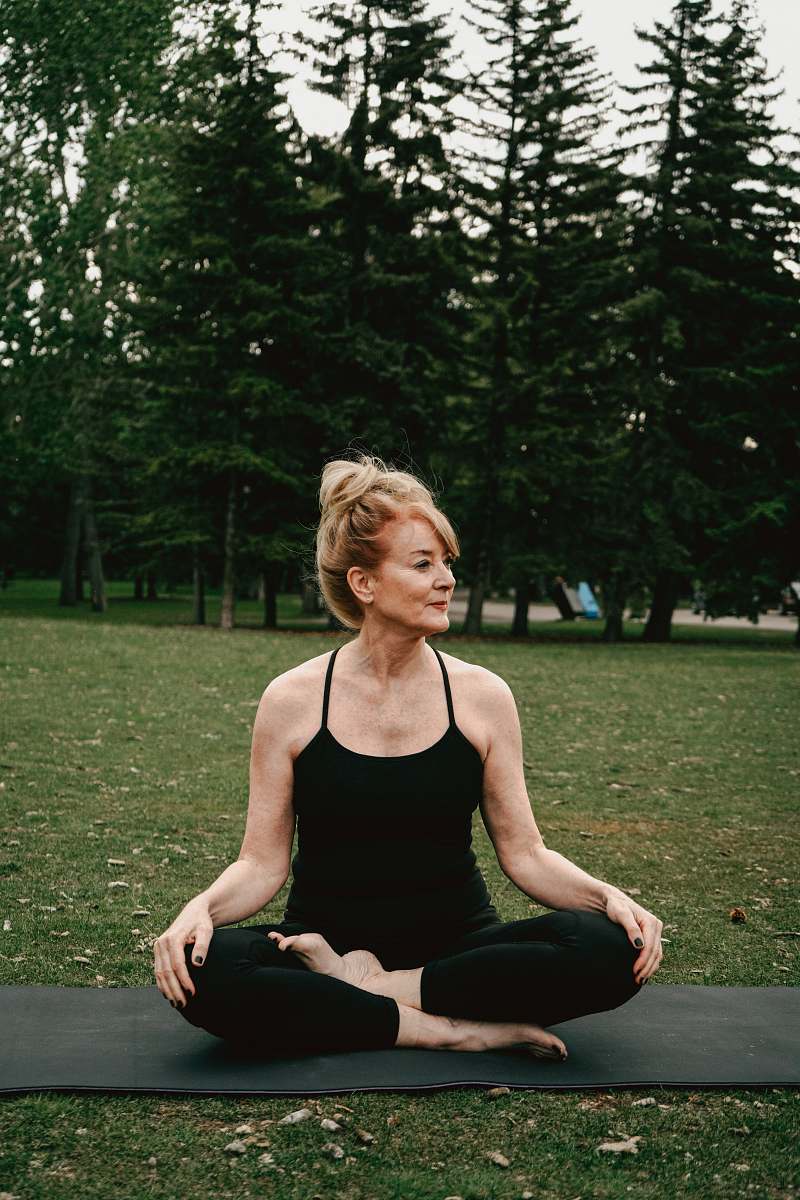 human woman squatting on a yoga mat working out