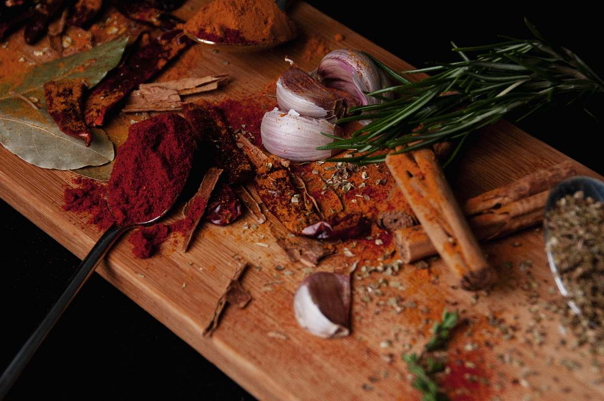 food view of sliced red onions paprika and bay leaves wood