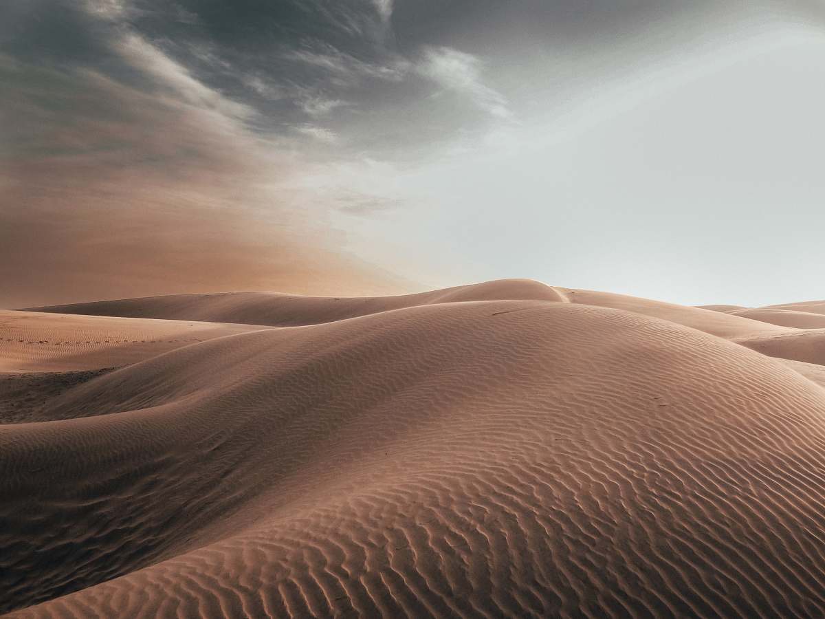 soil sand dunes at desert under grey cloudy sky nature