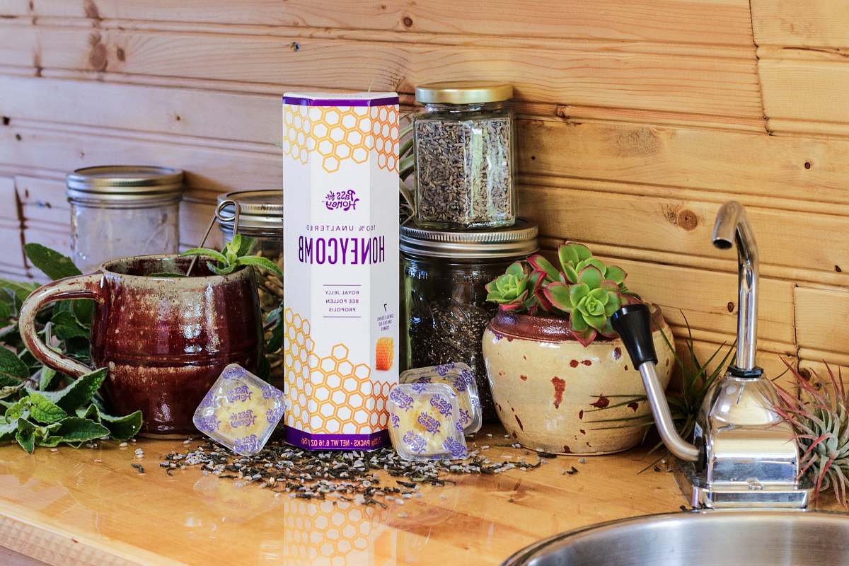 furniture honey container beside clear glass jars tabletop