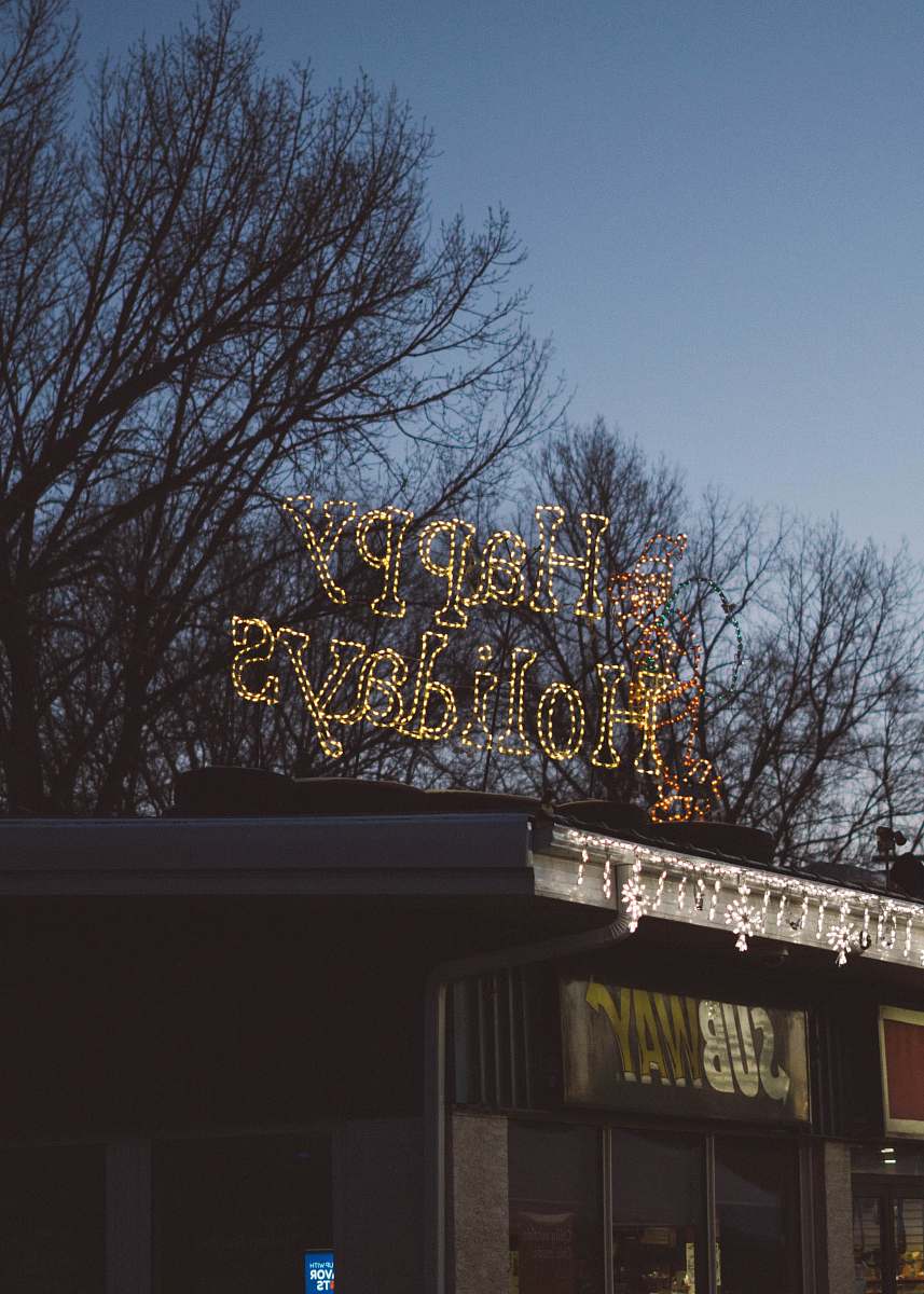 grey Happy Holidays LED signage during daytime lumsden