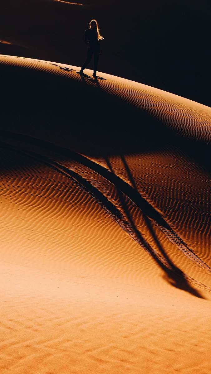 nature woman walking on desert sand