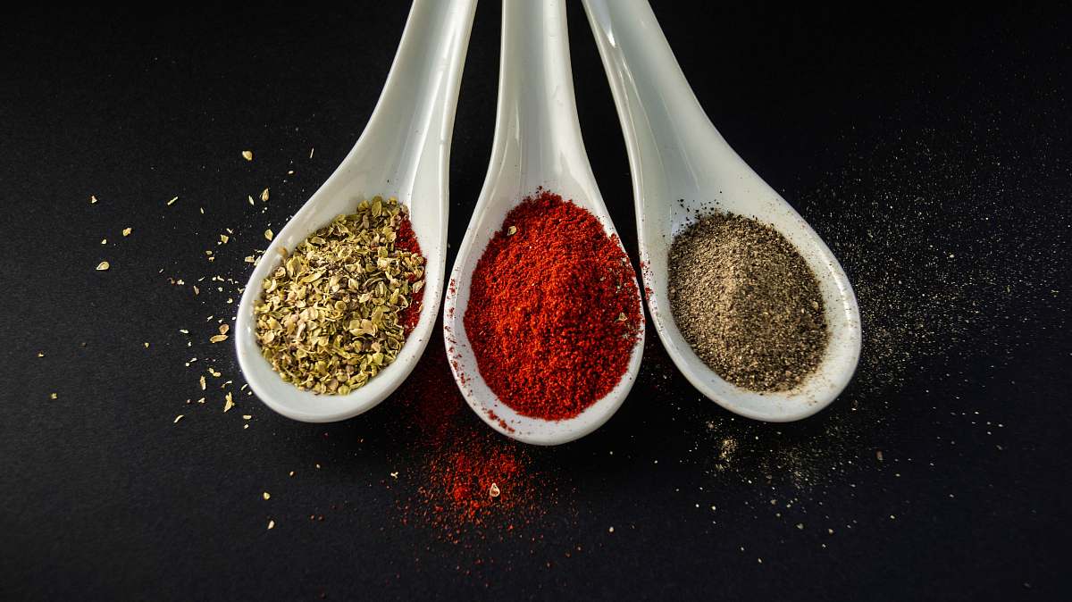 brown three assorted spices in white spoons 