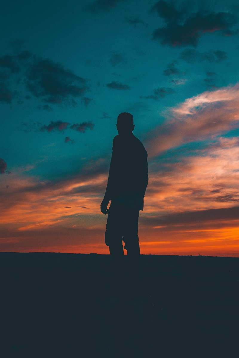 cloud silhouette on man standing on ground dark