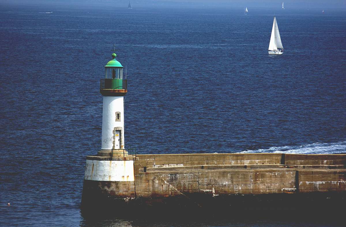 beacon lighthouse near body of water lighthouse