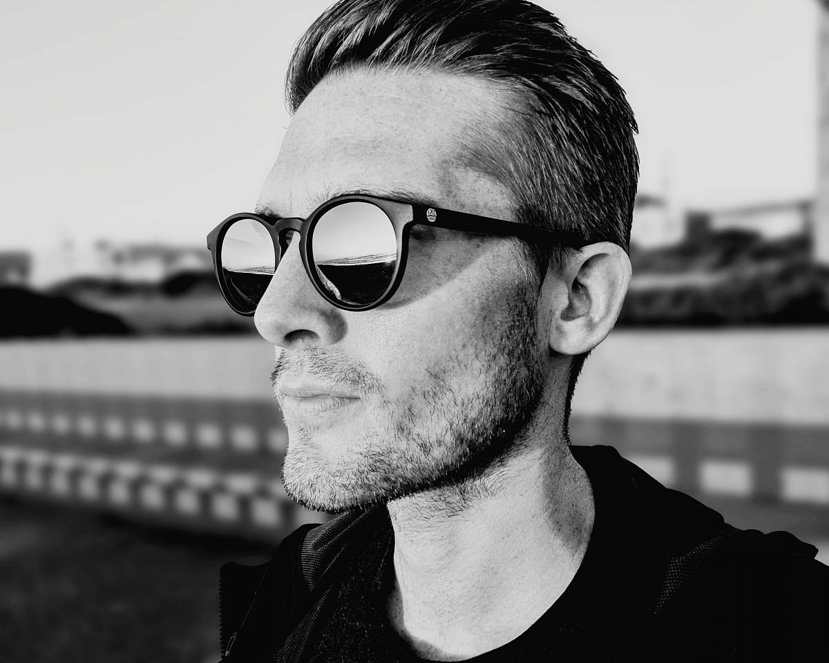 person grayscale photography of man wearing sunglasses people