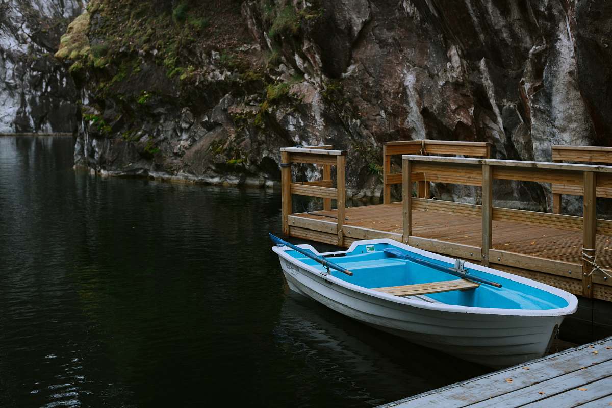 jetty white and blue boat on dock ruskeala