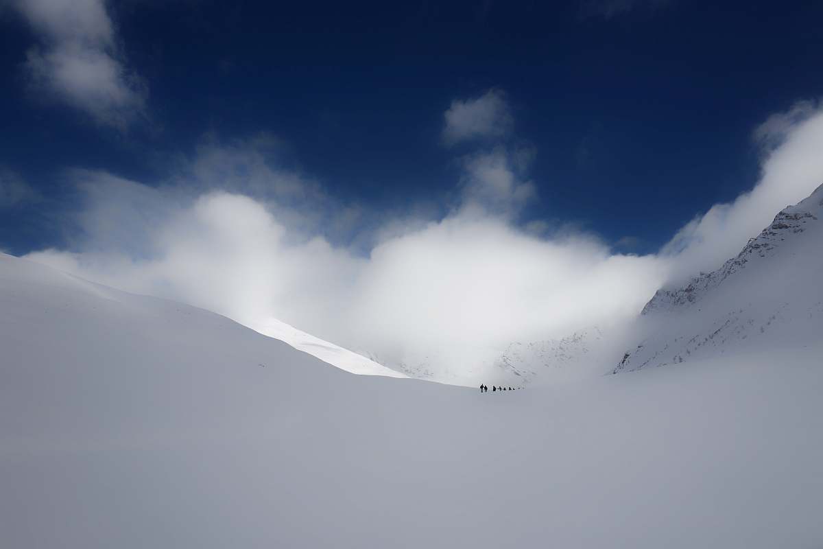nature people walking on snow under cloudy sky winter
