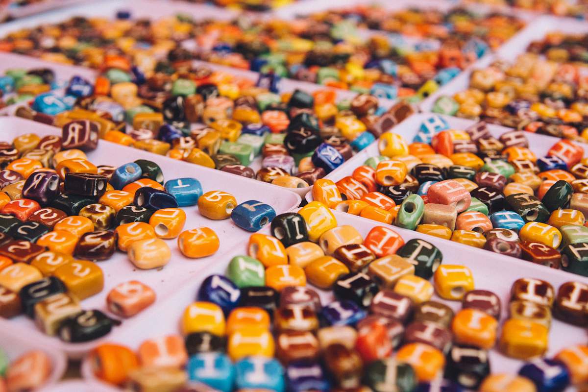 letter assorted-color bead lot on white tray abc