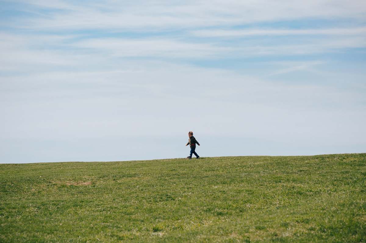 grassland child walking on green grass field grass