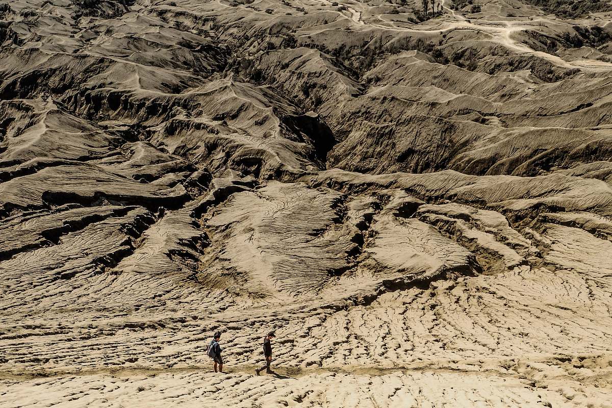 sand brown mountain range with two people soil