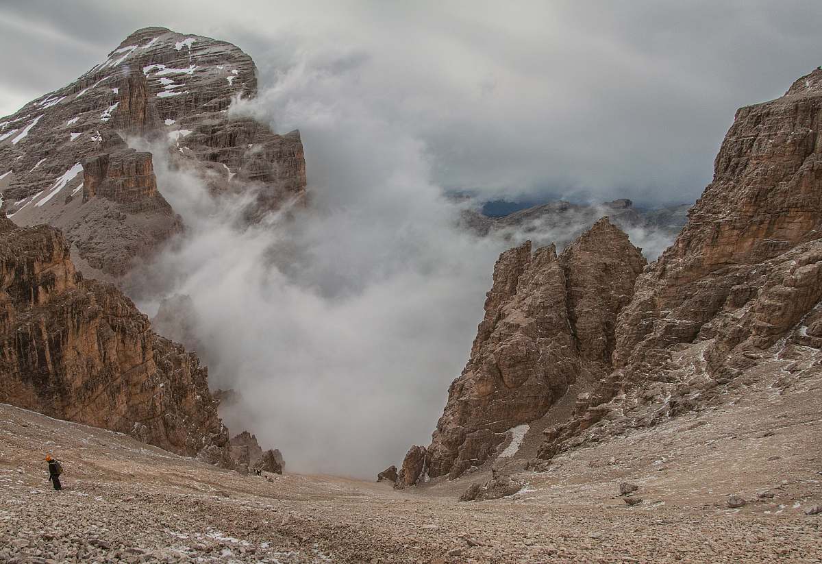 slope landscape photography of foggy mountain rocks cloud