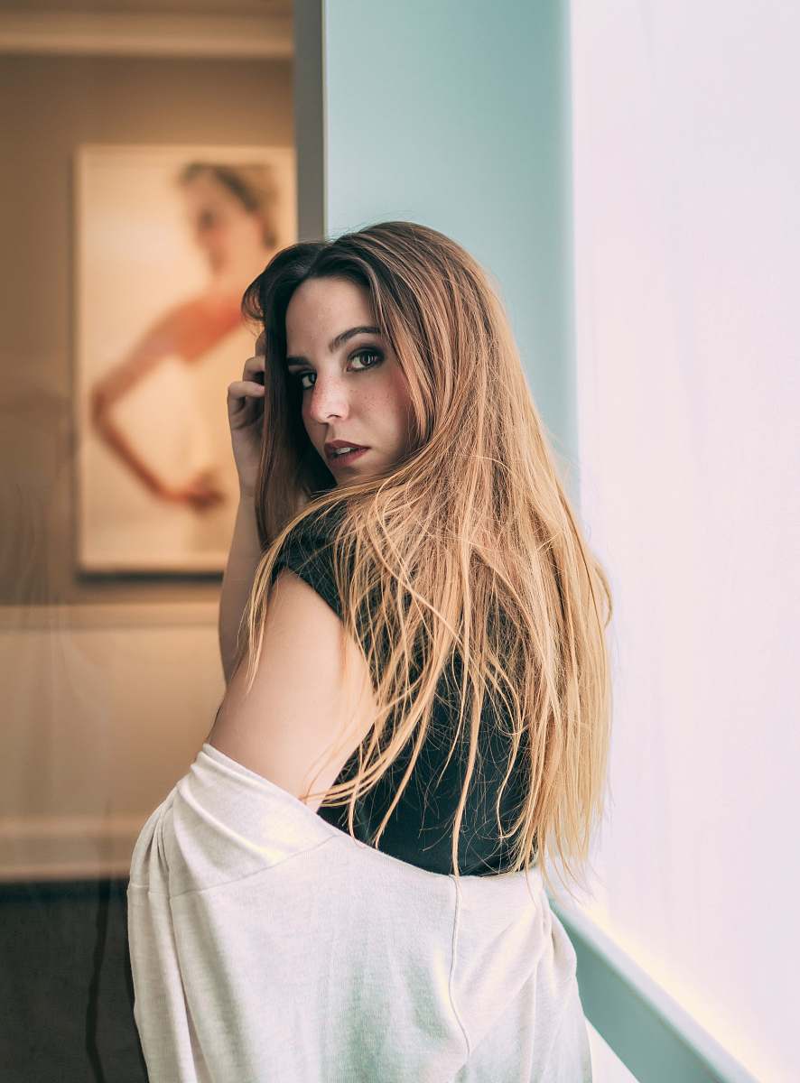 human woman taking her cardigan off person