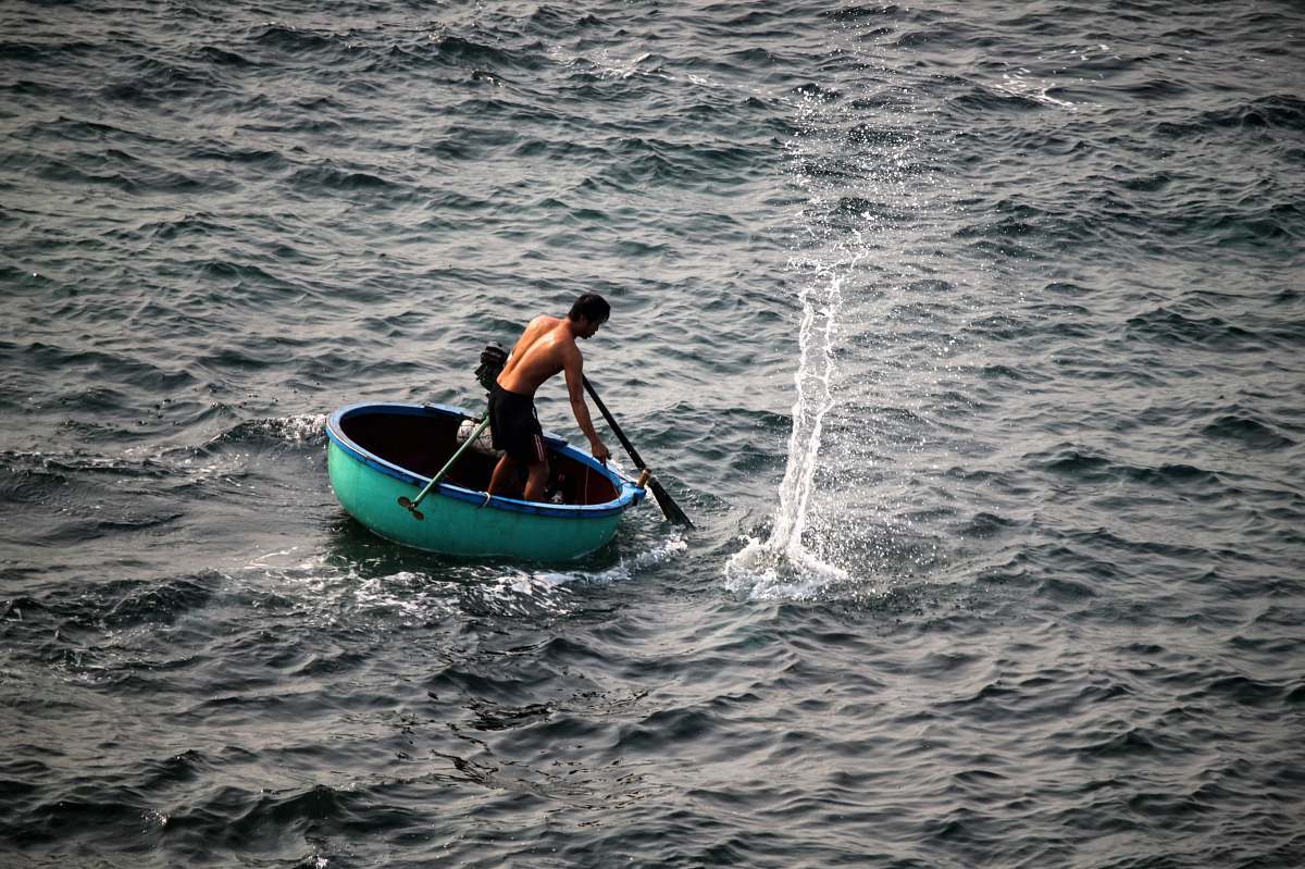 human man riding on round green boat at daytime people