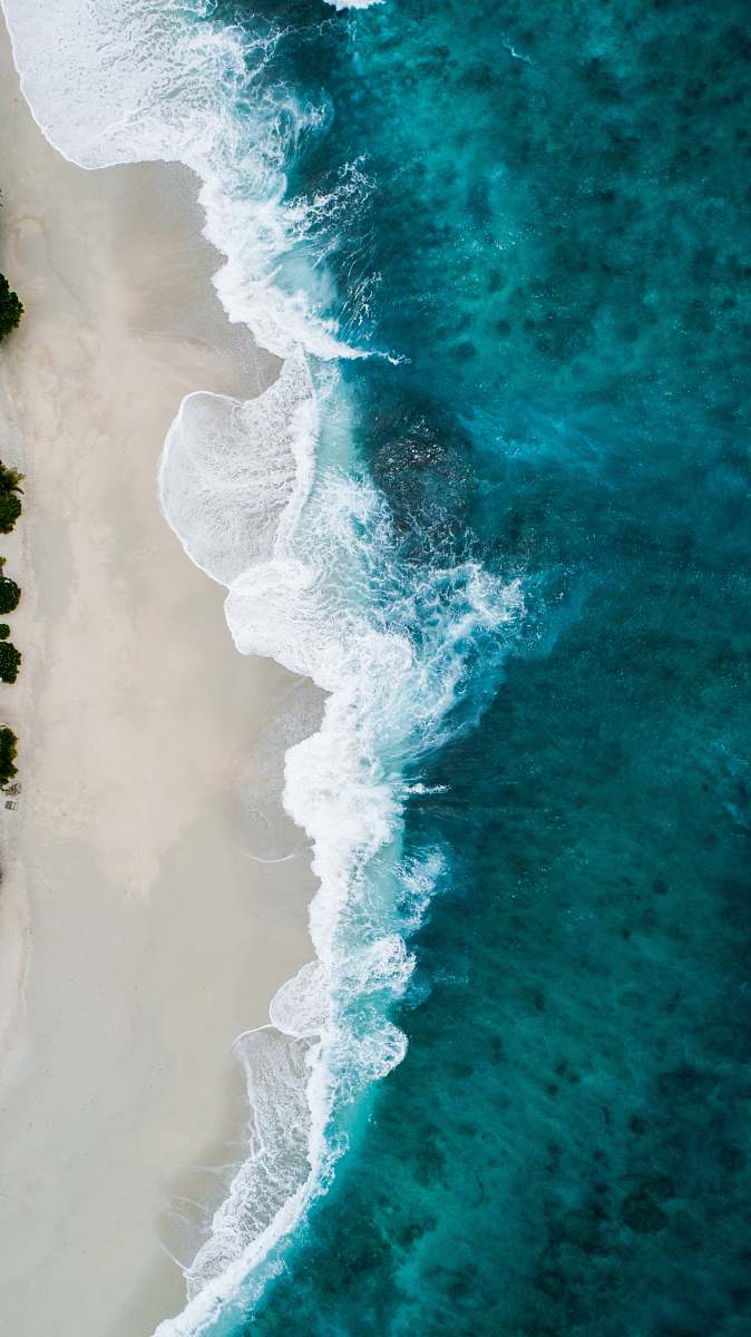nature aerial photography of large body of water and shoreline ocean