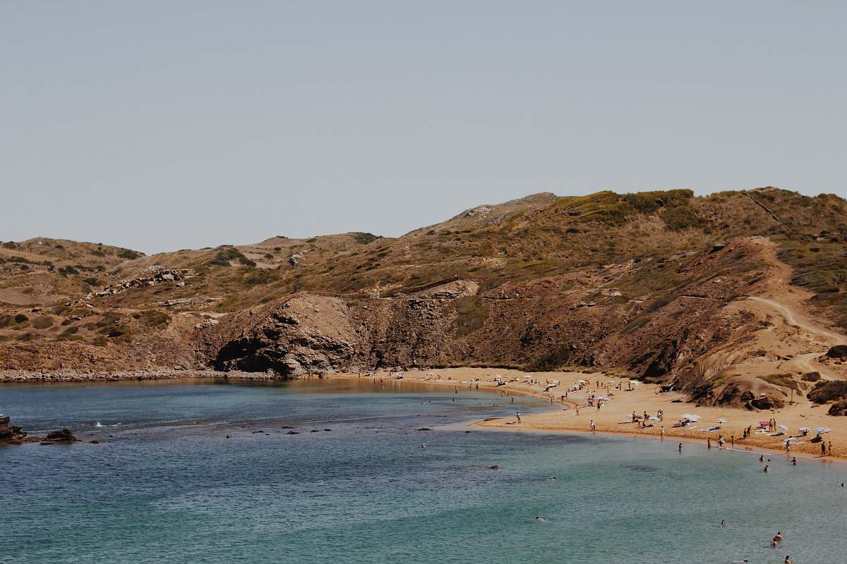 sea people near seashore swimming and standing during daytime photography water