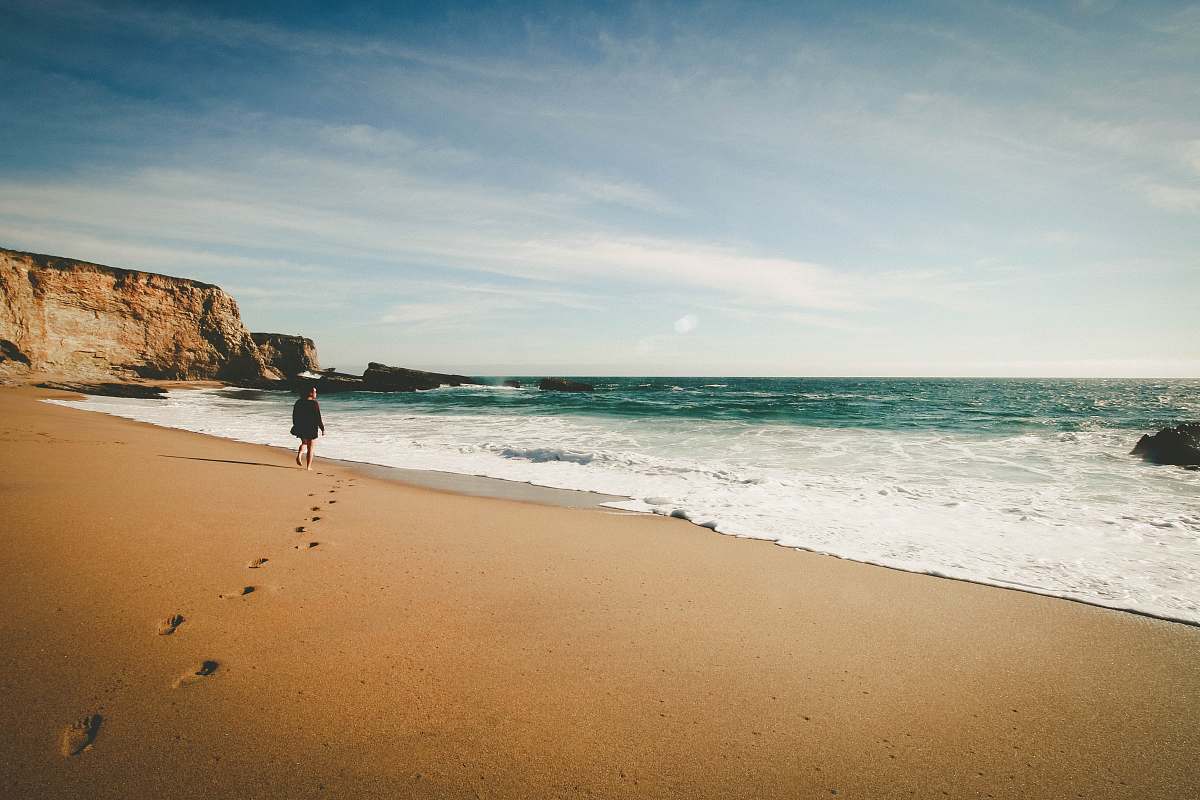 sea person walking on seashore ocean