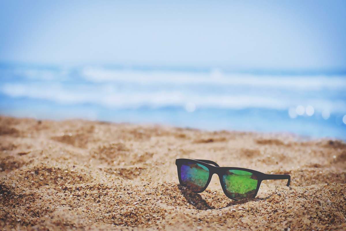 summer wayfarer sunglasses on beach sand during daytime sunglasses