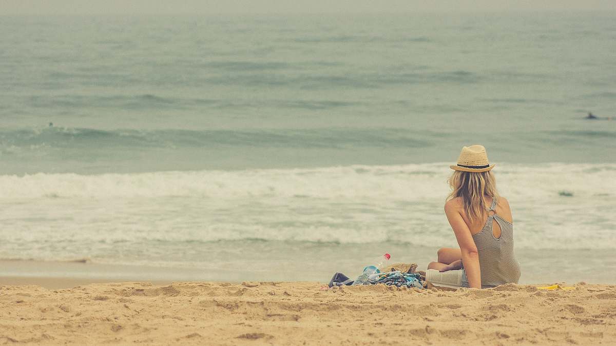 ocean woman sitting on seashore sea