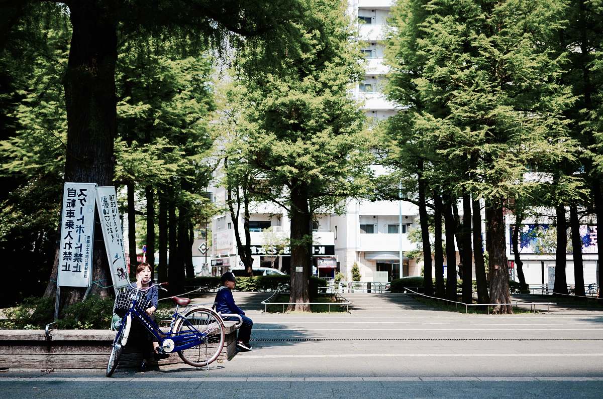 bike woman sitting on concrete block building