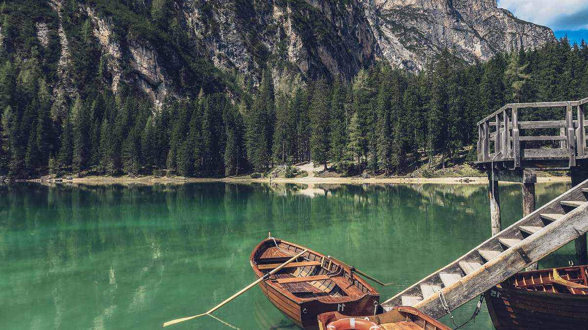 italy brown canoe docking on gray wooden staircaes rowboat