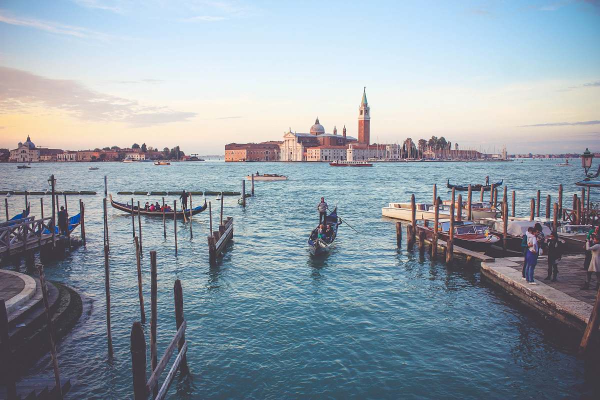 gondola photography of of people near boat during daytime dock