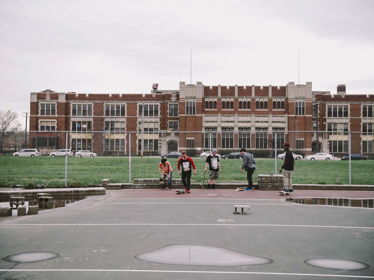 detroit group of people near brown building boys