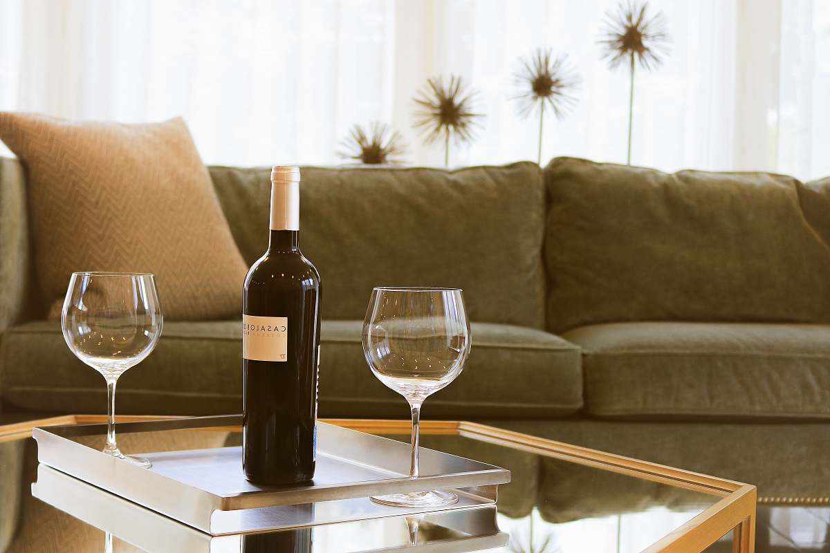 interior black wine bottle beside two wine glasses wine