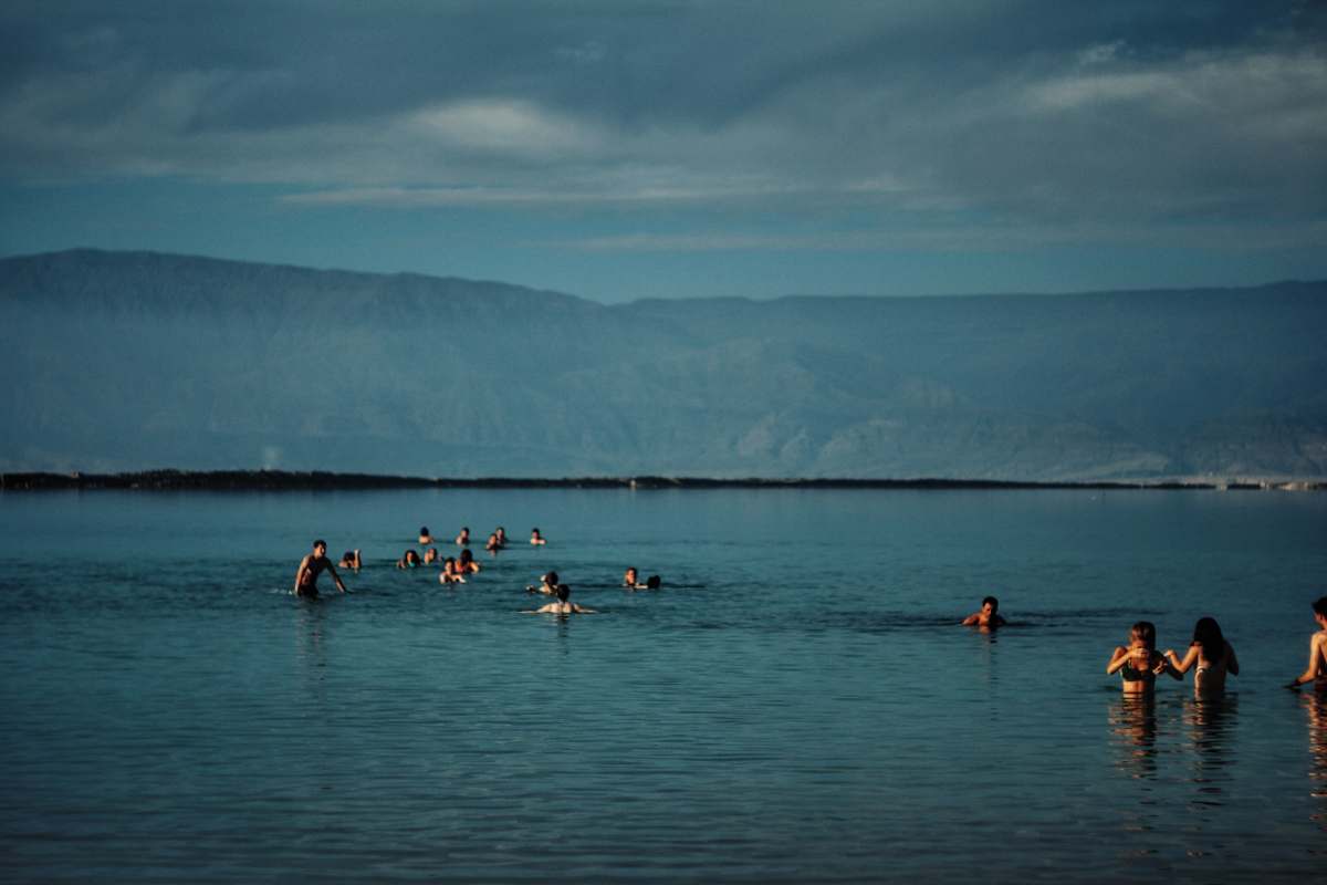 people group of people in body of water near green mountain israel