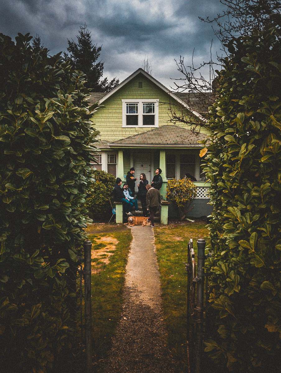path people standing near closed door house building