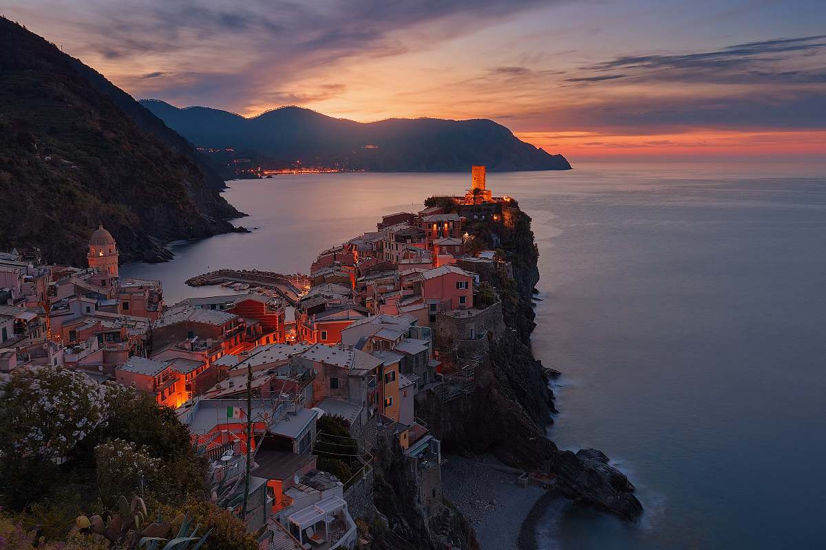 building aerial view of village on mountain cliff during orange sunset city
