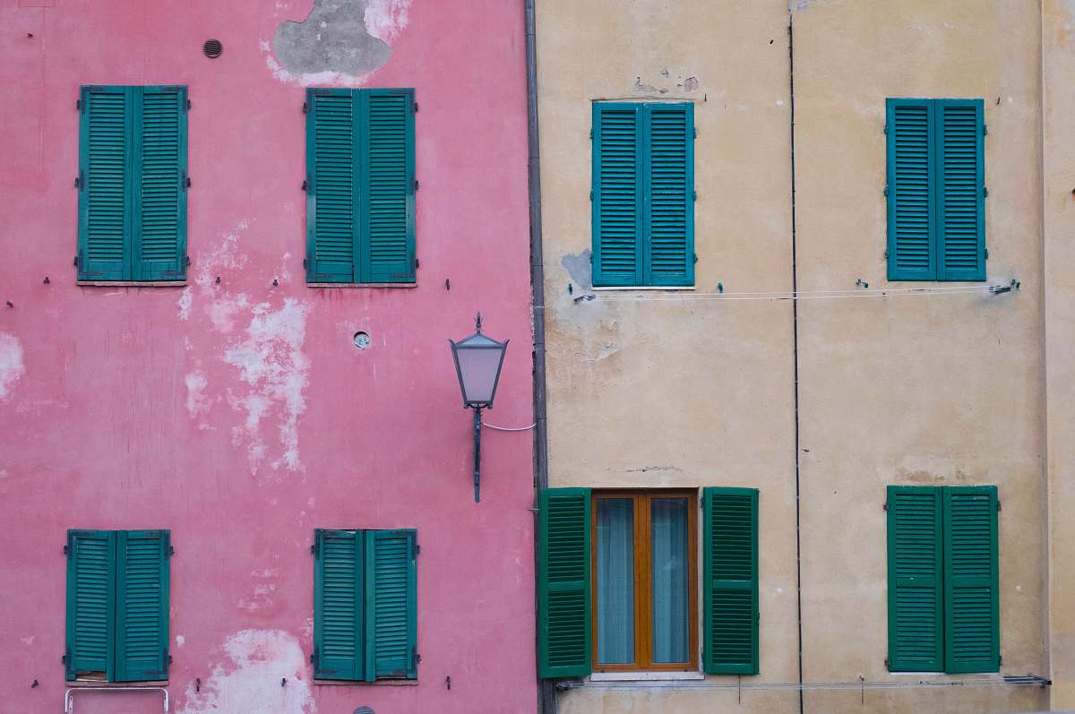 window black outdoor sconce on pink painted wall shutter