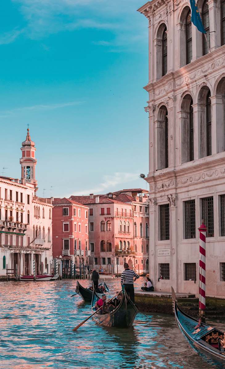 gondola canal between buildings during daytime venice