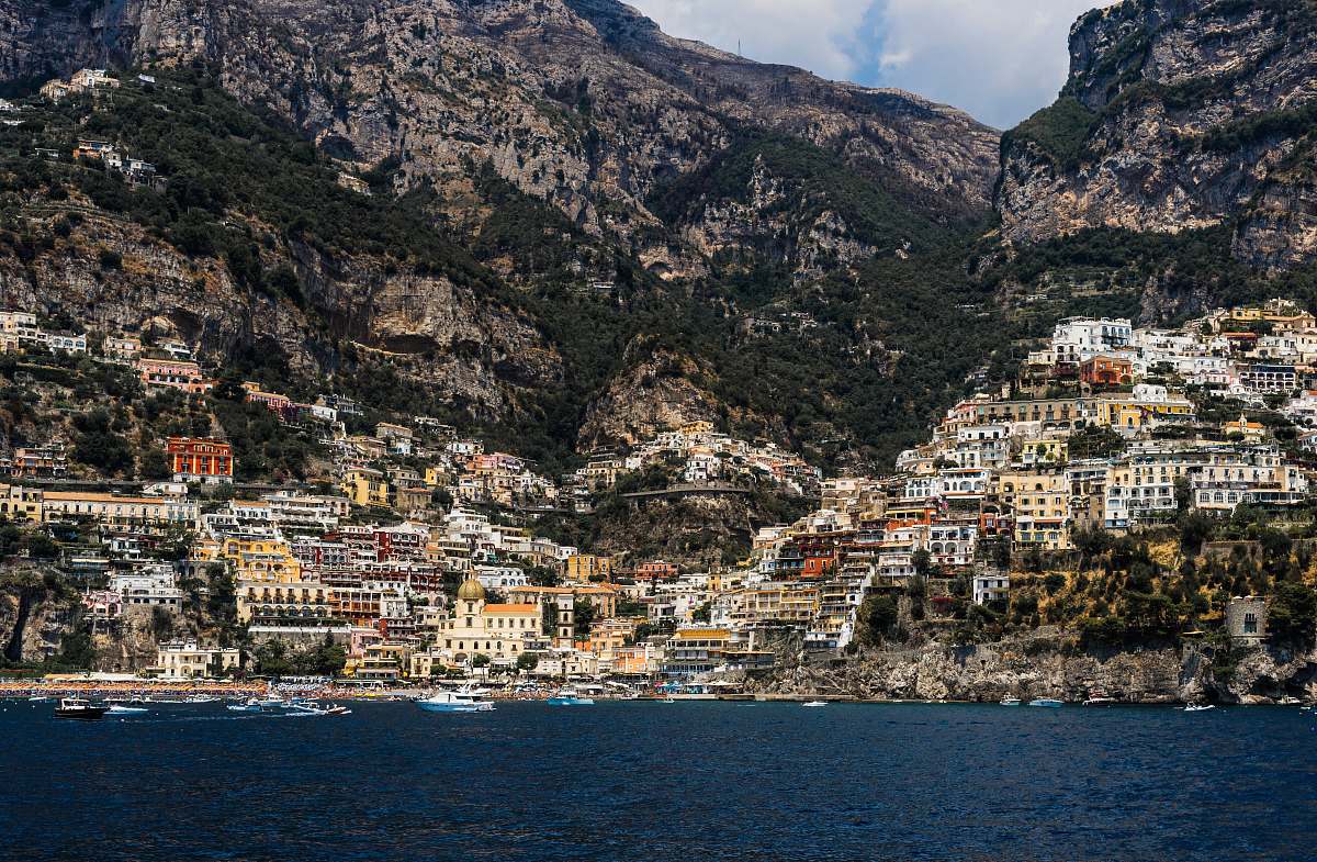 city concrete buildings on mountain near body of water at daytime town