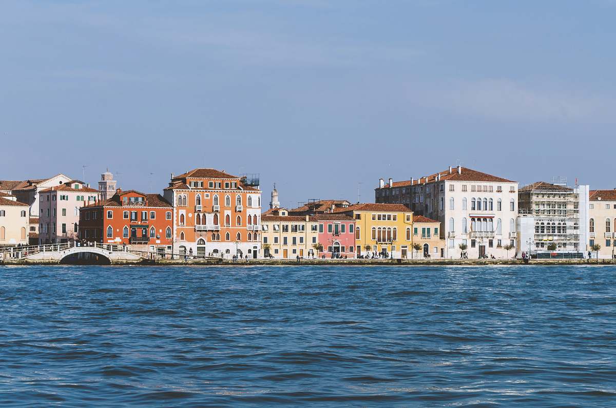 building concrete houses and bridge near body of water venice