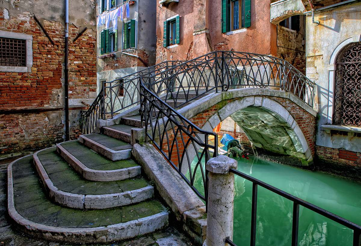 brick orange and gray stone bridge during daytime handrail