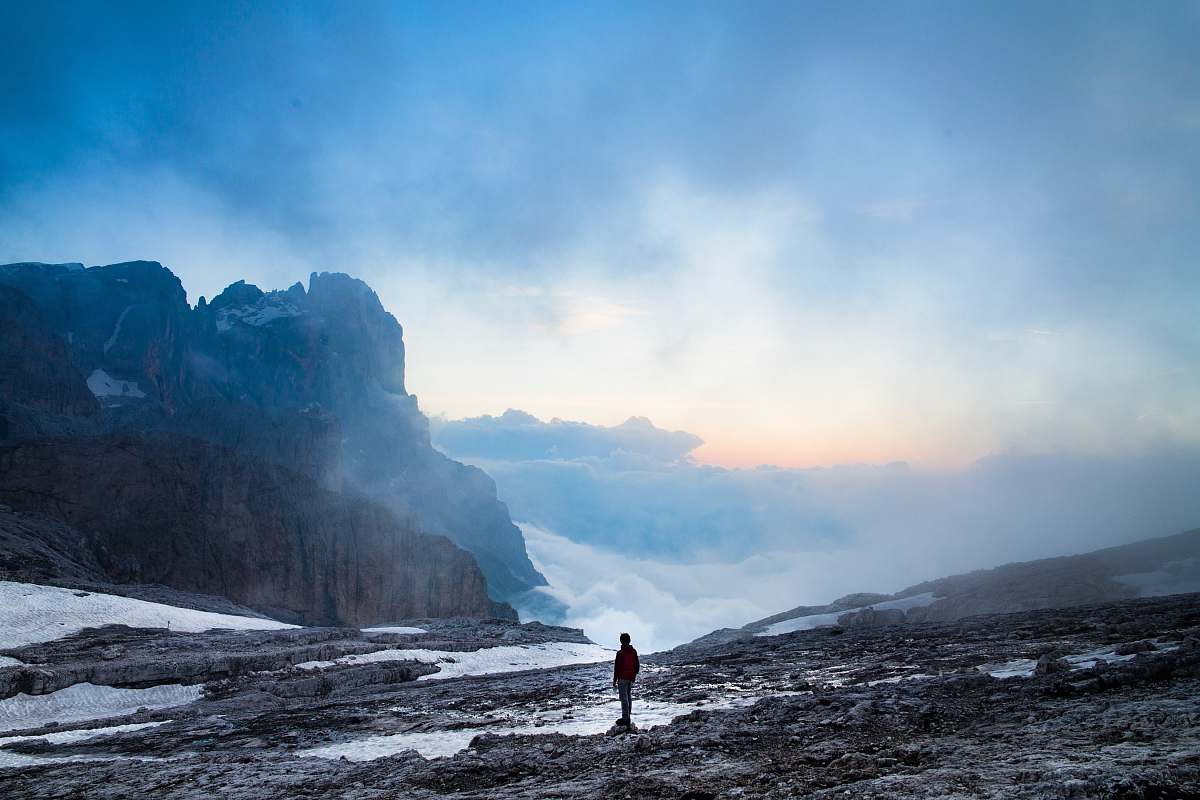 nature person standing near the cliff of the mountain snow