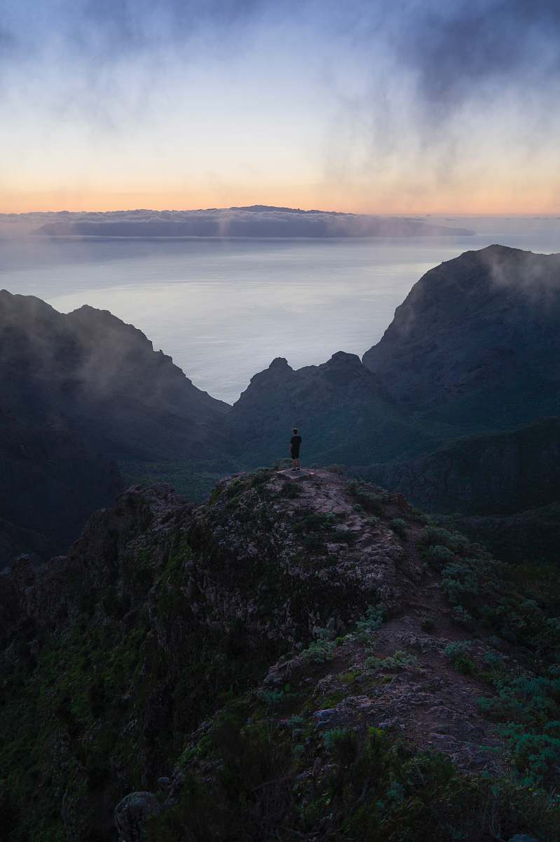 dawn person standing on rock monolith dusk